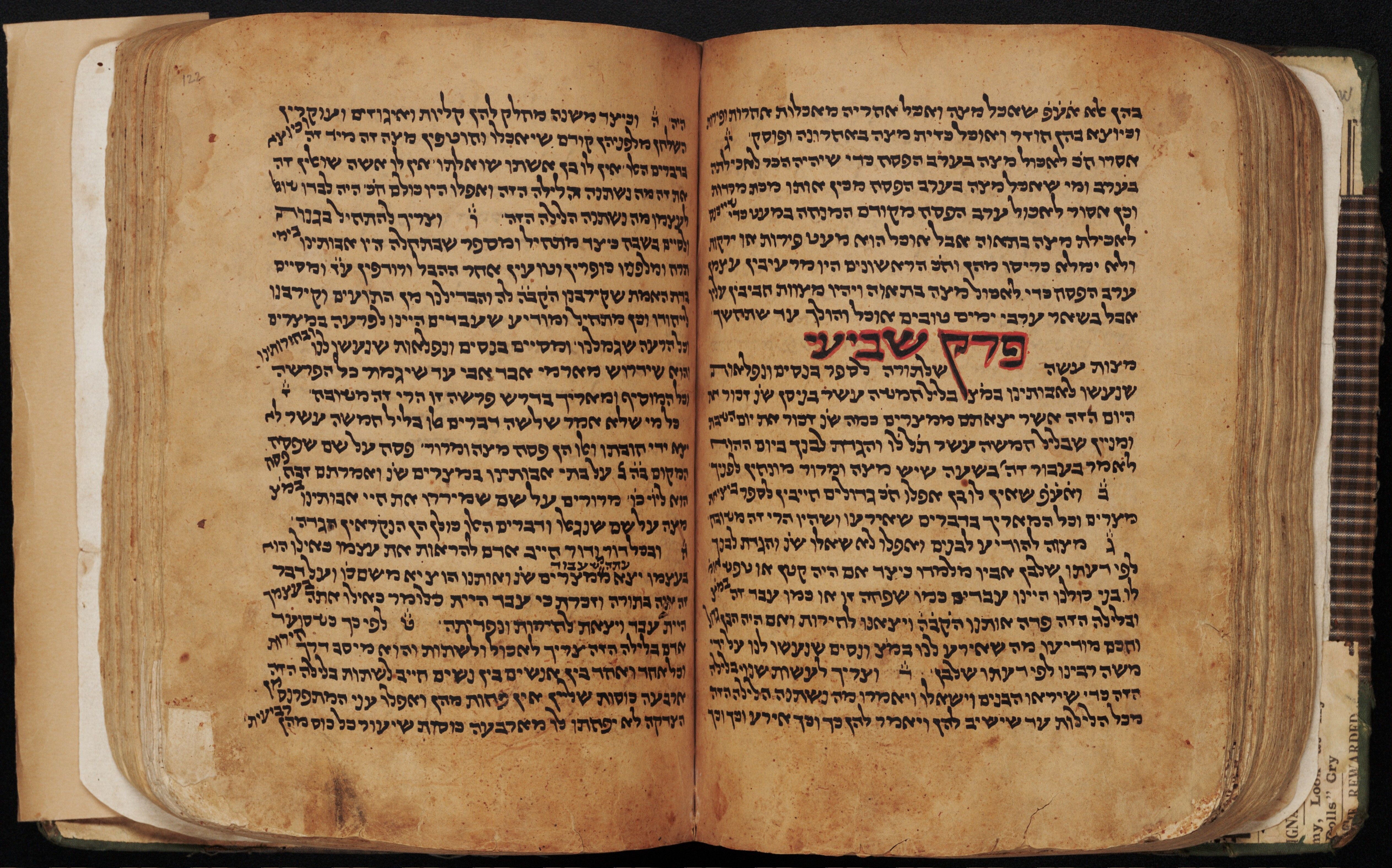 MS Hebrew 1 Opening of a manuscript showing two facing pages of Hebrew in black ink, organized in single columns. Heading is outlined in bright red.