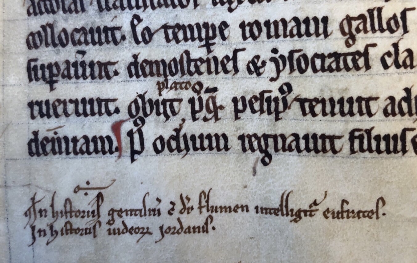 A close-up of a medieval manuscript page with black text.