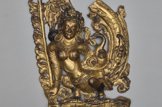 Kinnari. 13th-14th Century. Yale University Art Gallery. Half bird, half human female figure crouching. She holds a long necked bird in the crook of her arm. Cast in gilt bronze. 