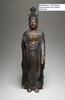 Bodhisattva, 14th Century. Yale University Art Gallery. A standing Bodhisattva figure dressed in clinging, flowing robes. The right hand is raised up to its chest and the left hand extends downward. 